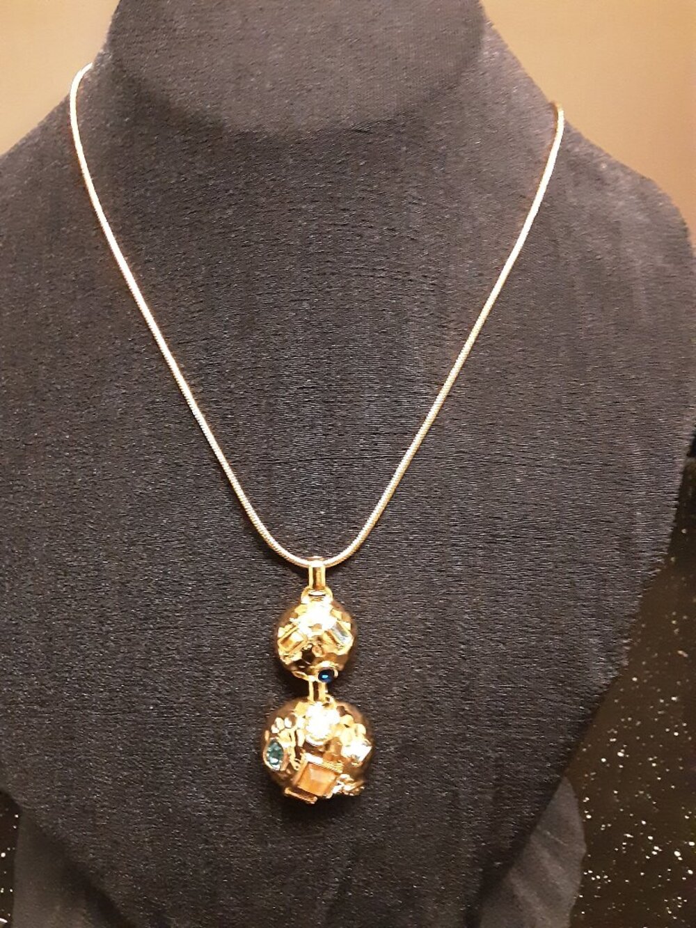 Gold-toned Necklace (features a heavy, dangling pendant)